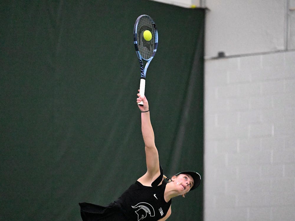 Issey Purser, a senior, serves during a singles match at the MSU Tennis Center on Friday, Feb. 6, 2026. Spartans recorded multiple serves exceeding 100 mph during the match