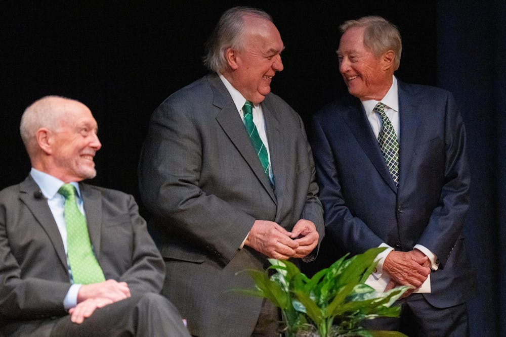 Ted Mitchell, president of the American Council on Education and former U.S. under secretary of education, and former Michigan governors John Engler (1991–2002) and James Blanchard (1983–1990) laugh during the first Presidential Speaker Series at the Wharton Center for Performing Arts on Michigan State University’s campus in East Lansing, Mich., on Tuesday, March 17, 2026.