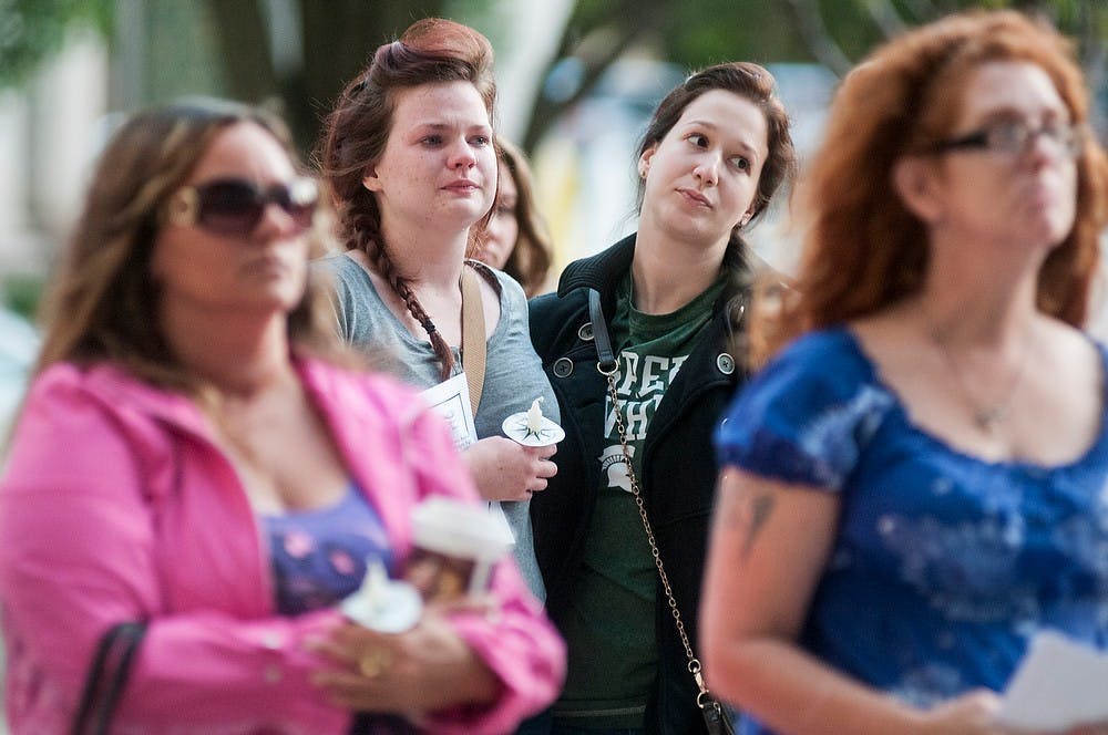 	<p>Lansing resident Amber Mandalari, right, comforts graduate student Cortney Vandegrift, left, on Oct. 3, 2013, outside the Lansing City Council Office. The event was meant to honor those who have been affected by domestic violence. Khoa Nguyen/The State News</p>