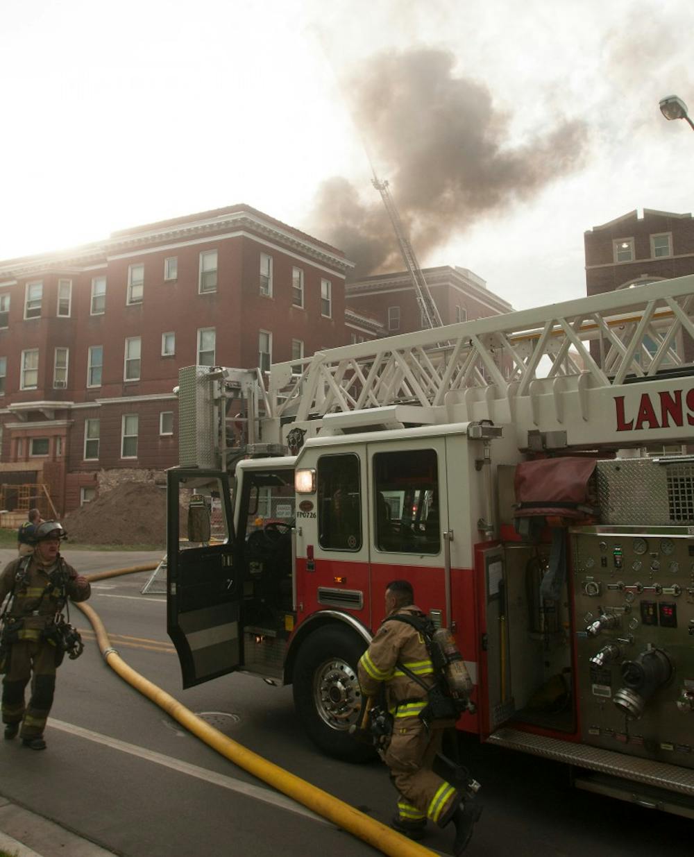 <p>Fire Fighters respond to a fire May 15, 2013, at Morrill Hall. The cause of the fire is still unknown. Weston Brooks/The State News</p>
