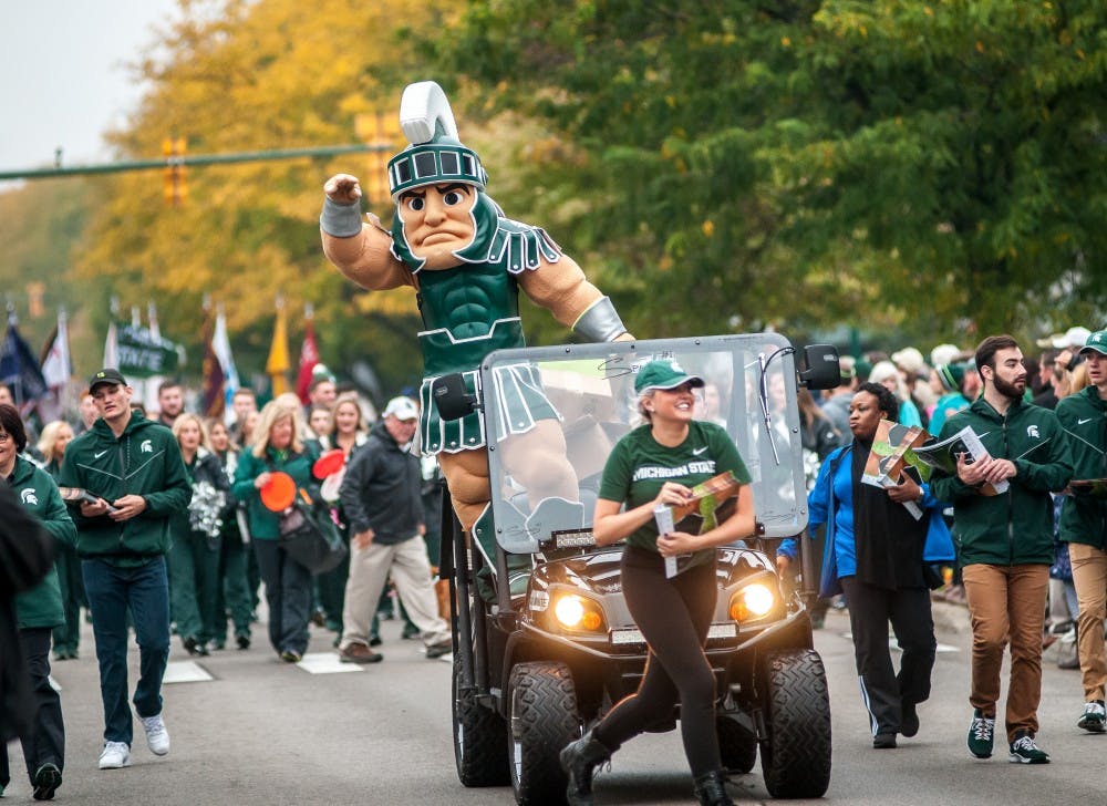 <p>Sparty rides along during the MSU Homecoming Parade on Oct. 5, 2018 along Grand River Avenue.</p>
