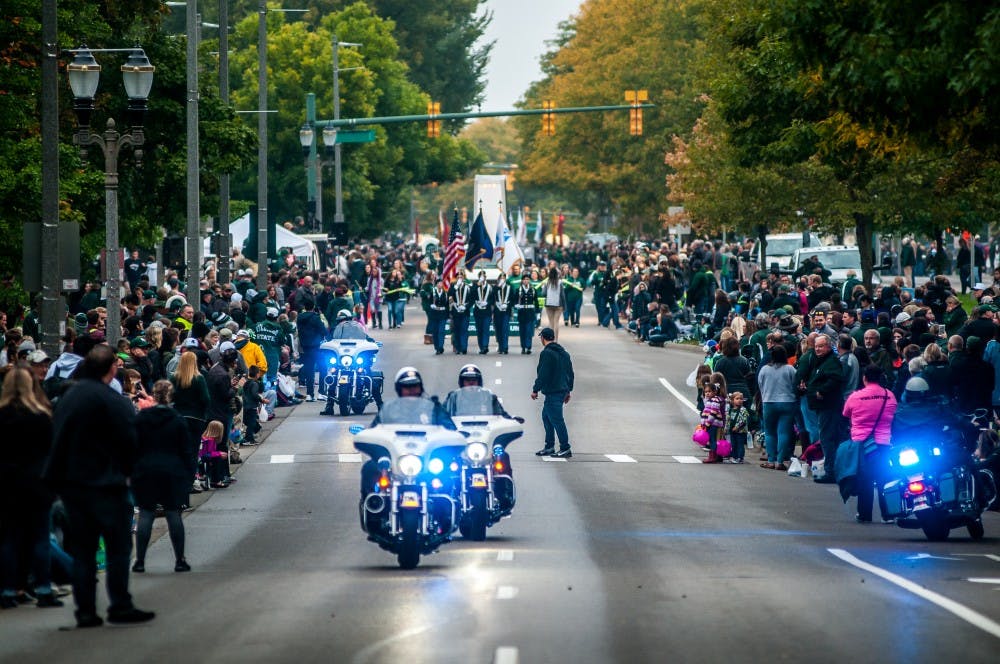 <p>Police officers on motorcycles lead the way for the start of the parade during the MSU Homecoming Parade on Oct. 5, 2018 along Grand River Avenue.</p>