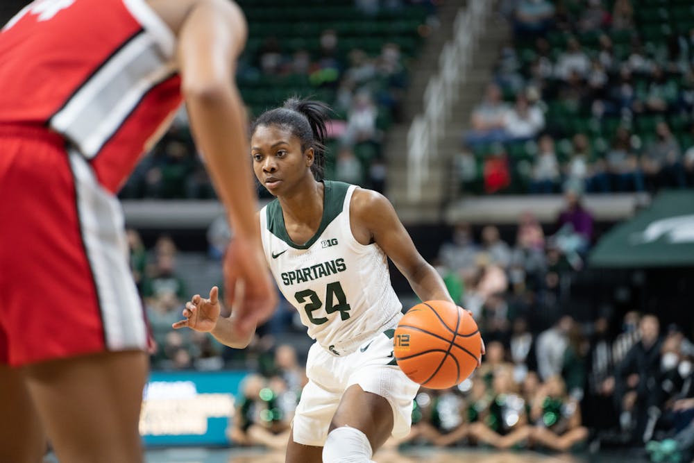 <p>Senior guard Nia Clouden (24) dribbles up the court. The Spartans lost 61-55 against Ohio State University at the Breslin Center on Feb. 27, 2022.</p>