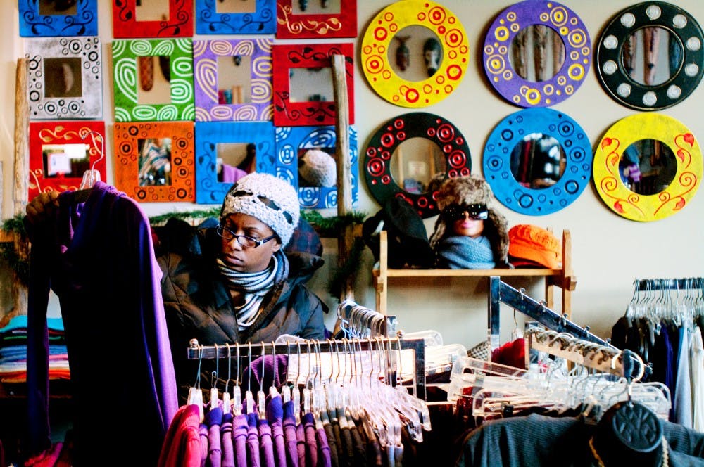 Lansing resident Danielle Nicole Mitchell peruses the racks at La Bodega on Friday afternoon. East Lansing businesses took part in a city-wide Green Friday shopping event which promoted local shopping during the holiday season. Josh Radtke/The State News