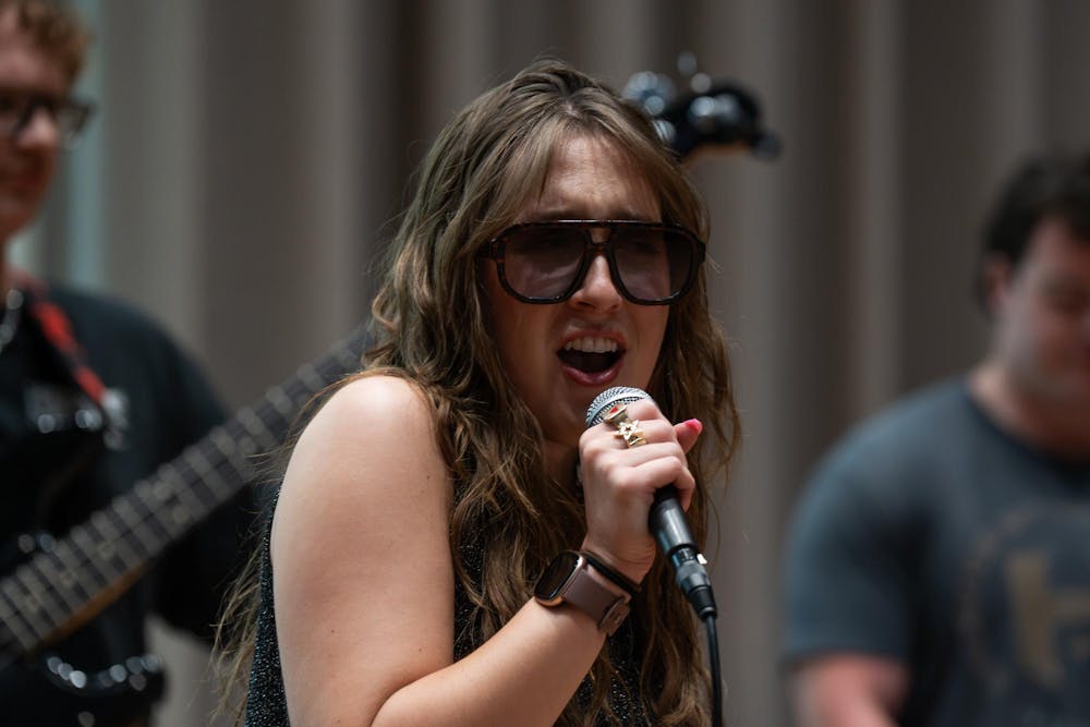 <p>Luke Karsten, Alina Morse and Kade Ringer (from left) practice for their band, Roxy Riot, at the MSU Music Building in East Lansing, Mich., on July 17, 2026.</p>