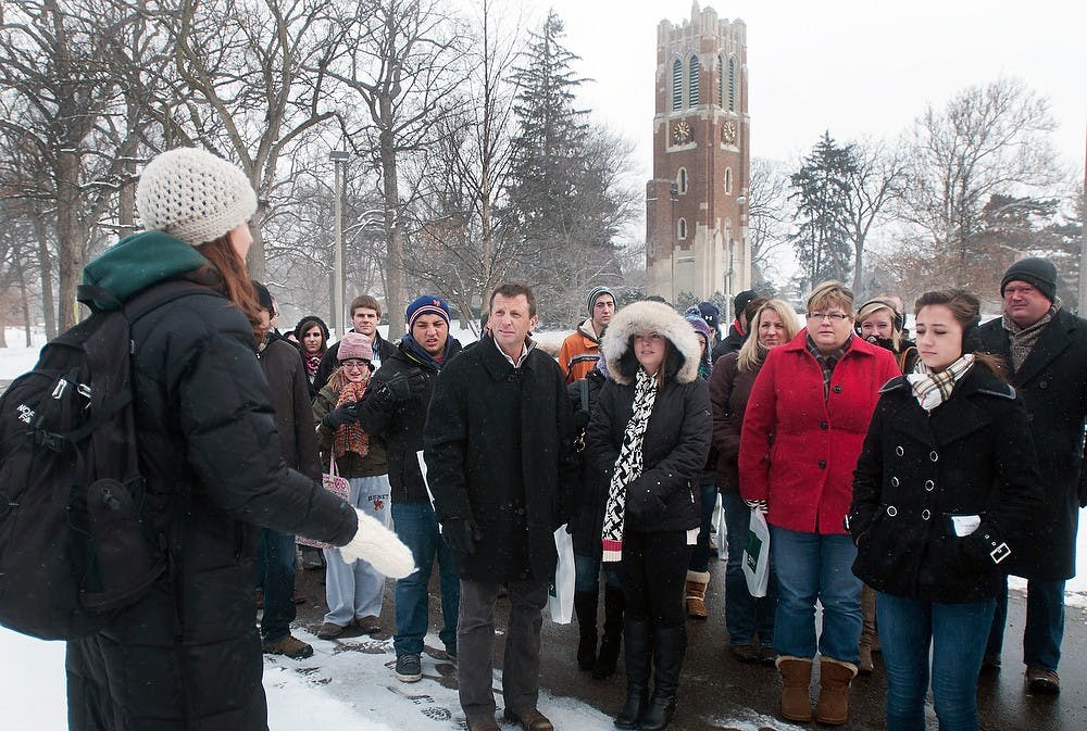 	<p>Interdisciplinary studies senior Kelsey Lash gives Inside <span class="caps">MSU</span> tour attendees background information about the campus outside of the <span class="caps">MSU</span> Main Library on Monday, Jan. 21, 2013. The program offered potential freshman and family members the opportunity to see the campus and ask other students and advisors questions about financial aid and on-campus life. Danyelle Morrow/The State News</p>