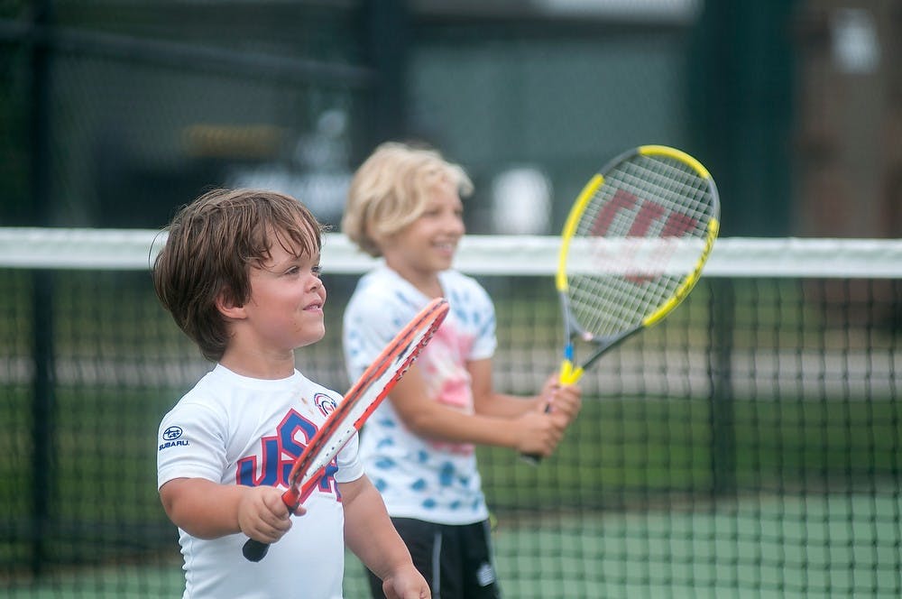 	<p>Indianapolis resident Eric Dessaver, 8, left and Tillsonburg, Ontario, resident Charlotte Bolton, 10, play doubles tennis Aug. 6, 2013, during the World Dwarf Games at the tennis courts on Wilson Road. The two were just having fun on their day off. Weston Brooks/The State News</p>
