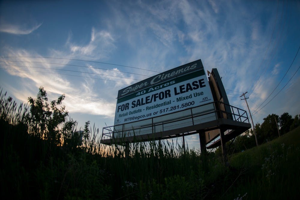 A sign for the Super Cinema property pictured on May 31, 2016 at 6365 Newton Road in East Lansing. The property is currently over grown with debris but encompasses a total of 40 acres.