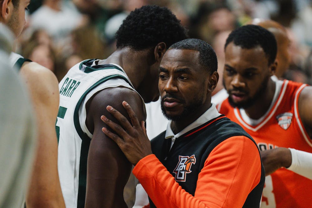 <p>MSU basketball alumni and Bowling Green assistant coach Lourawls "Tum Tum" Nairn Jr. shakes hands with MSU sophomore forward Coen Carr (55) after MSU beat Bowling Green 86-72 at the Breslin Center on Nov. 16, 2024</p>