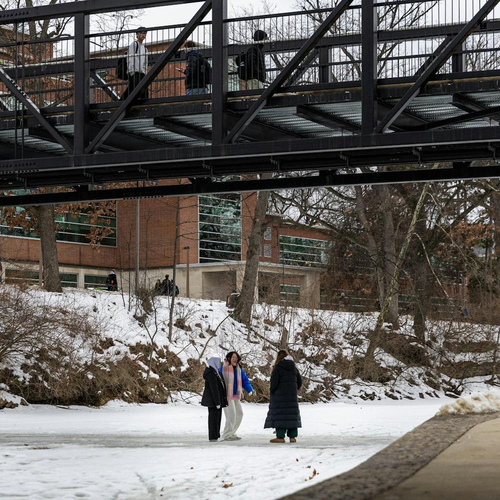 MSU students hang out on the frozen over Red Cedar River in East Lansing, MI on Feb. 11, 2026.