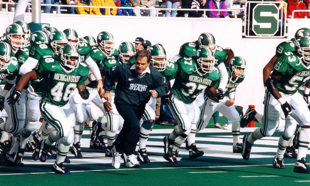 Former Michigan State head coach Nick Saban runs out with the team. Saban coached Michigan State from 1995-1999.