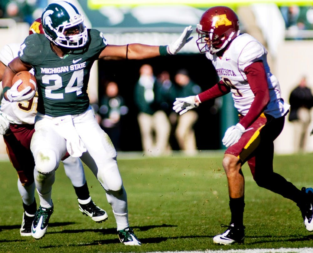 Sophomore running back Le'Veon Bell stiff arms defensive back Christyn Lewis as Lewis tries to tackle Bell.The Spartans defeated the Golden Gophers 31-24 on Saturday at Spartan Stadium. Anthony Thibodeau/The State News