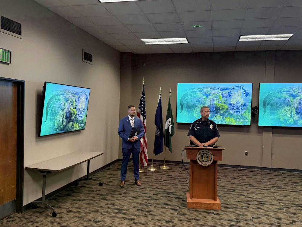 <p>Chief of Police and Executive Director of Public Safety at Michigan State University Mike Yankowski gives a speech with Detective Sergeant Aaron Schroeder standing on the left in East Lansing, Mich., on Friday, Sept. 11, 2026.</p>