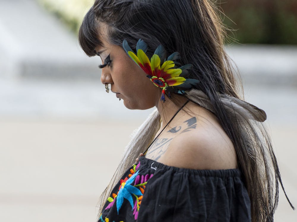 <p>Sienna Guerrero, or Tekpachikuauhtli, looks on during the Indigenous Peoples Day march led by NAISO and ILSO on Monday, Oct. 10, 2022. </p>
