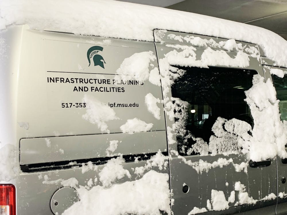 A snow-covered Michigan State Infrastructure Planning and Facilities van. Shot on Feb. 2, 2022. 