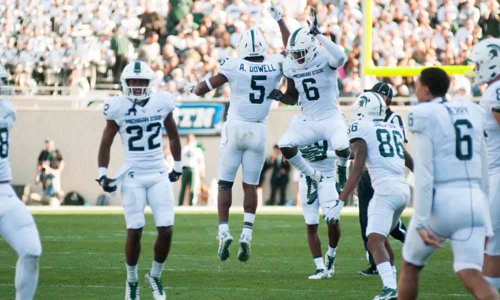 <p>Junior linebacker Andrew Dowell (5) and sophomore safety David Dowell (6) celebrate with teammates during the game against Western Michigan University on Sept. 9, 2017 at Spartan Stadium. The Spartans defeated the Broncos 28-14.</p>