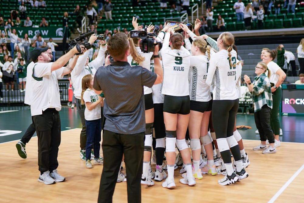 The Spartans celebrate winning their match against University of Michigan at the Breslin Student Events Center on Oct. 18, 2023. MSU clinched a 3-1 victory and claimed the "State Pride Flag," an award given to the winner of the MSU vs. U of M volleyball rivalry.