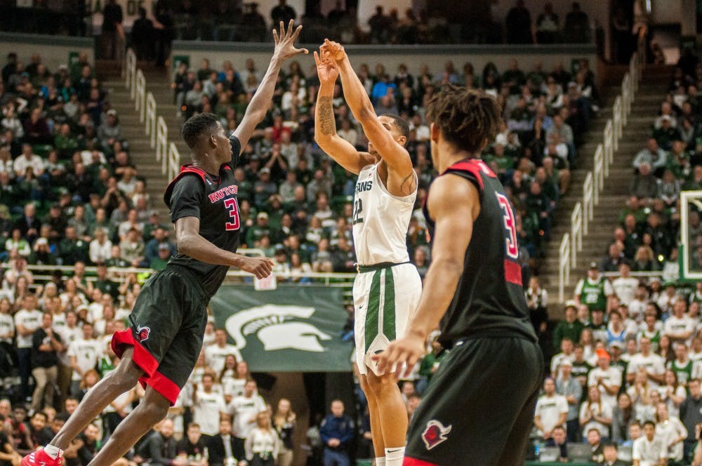 <p>Sophomore guard Issa Thiam (35) attempts to block sophomore guard Miles Bridges (22) during the game against Rutgers on Jan. 10, 2018 at Breslin Center. The Spartans narrowly beat the Scarlet Knights 76-72 in overtime.&nbsp;</p>