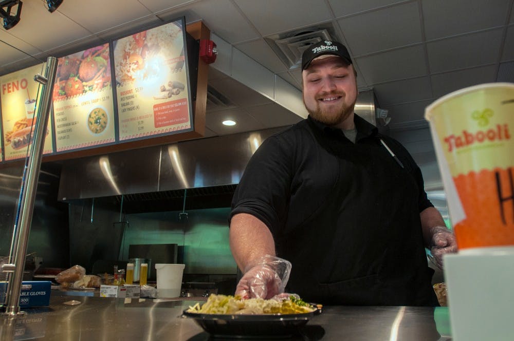 Restaurant manager Nick Florindi demonstrates serving a Mediterranean bowl on Sept. 16, 2016 in recently opened Tabooli restaurant at 515 W. Grand River Ave. The restaurant prepares all their food daily for freshness, and offers a variety of Mediterranean flavors. 