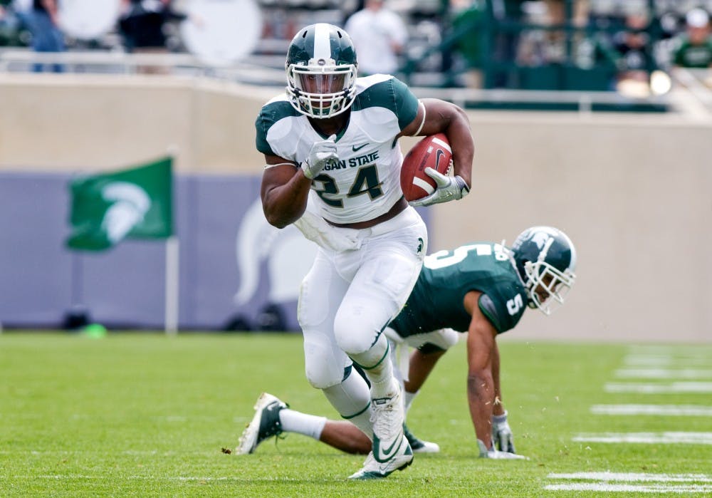 Then-sophomore running back Le'Veon Bell runs upfield leaving then-junior cornerback Johnny Adams behind at Spartan Stadium on April 30, 2011, at Spartan Stadium. State News File Photo