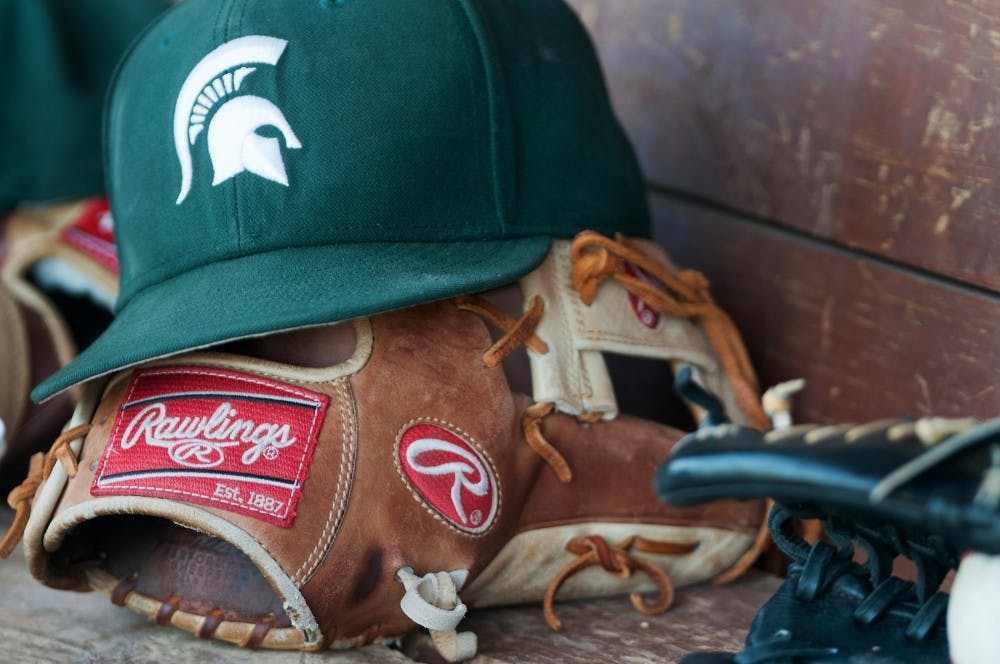 A Spartan baseball hat rests on a glove in the dugout on Friday afternoon May 18, 2012 at McLane Baseball Stadium at Old College Field. The Spartans lost to the Nittany Lions 6-5.