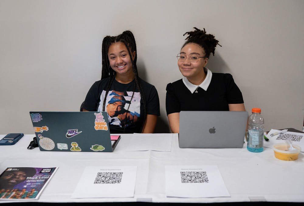 Chemistry sophomore Jessica Norwood and MSU’s African American Celebratory (AAC) organization Vice President and political senior Daiah Williams check in the Fall 2023 graduates’ family and friends for the Fall 2023 Black Grad event at the Union Ballroom on Dec. 8, 2023. 