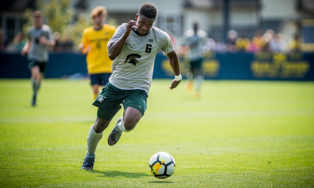 Junior forward DeJuan Jones (6) dribbles the ball up the field during the game against the University of Michigan on Sept. 17, 2017 at U-M Soccer Stadium. The Spartans defeated the Wolverines, 1-0.