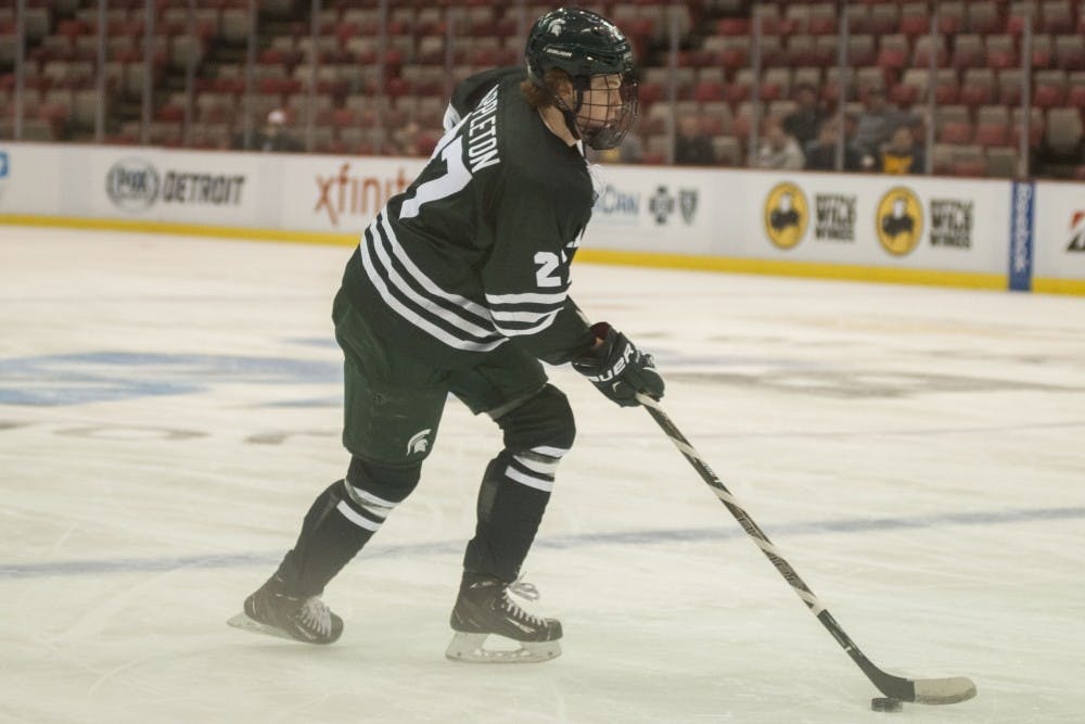 <p>Sophomore forward Mason Appleton (27) looks to make a pass during the first period of the first round of the Big Ten Hockey Tournament against Ohio State University on March 16, 2017 at Joe Louis Arena in Detroit. The Spartans were defeated by the Buckeyes, 6-3.</p>