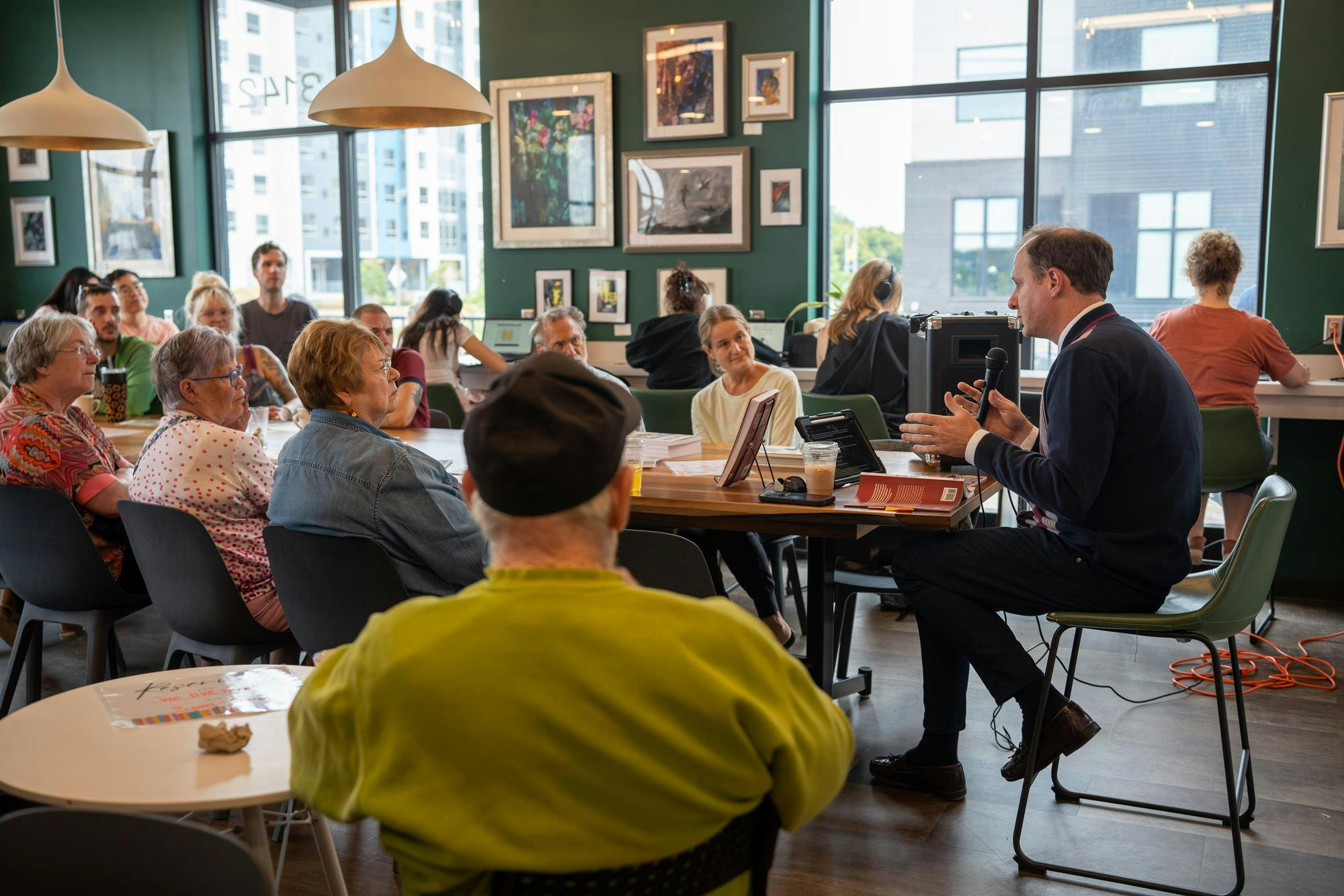 <p>Author Jeffrey Wilson spoke about his book&nbsp;<em>We Live Here!</em>&nbsp;during the adult author event and reading at Hooked Coffee Shop in Lansing on Sept. 22, 2024.</p>