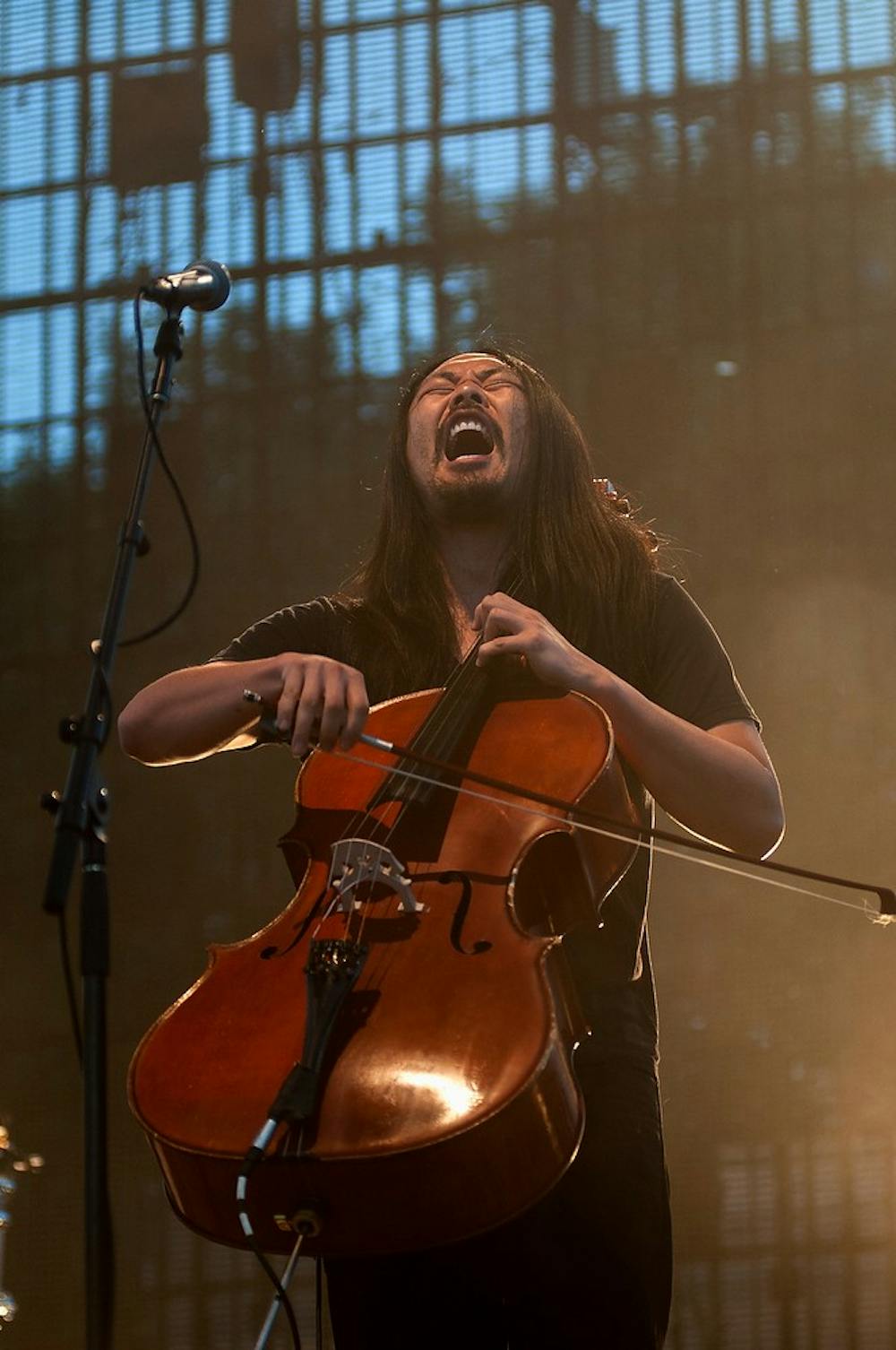 <p>The Avett Brothers cellist Joe Kwon performs on the main stage of Common Ground Music Festival, July 13, 2013, at Adado Riverfront Park in Lansing. The Avett Brothers were the headlining event of the day. Danyelle Morrow/The State News</p>