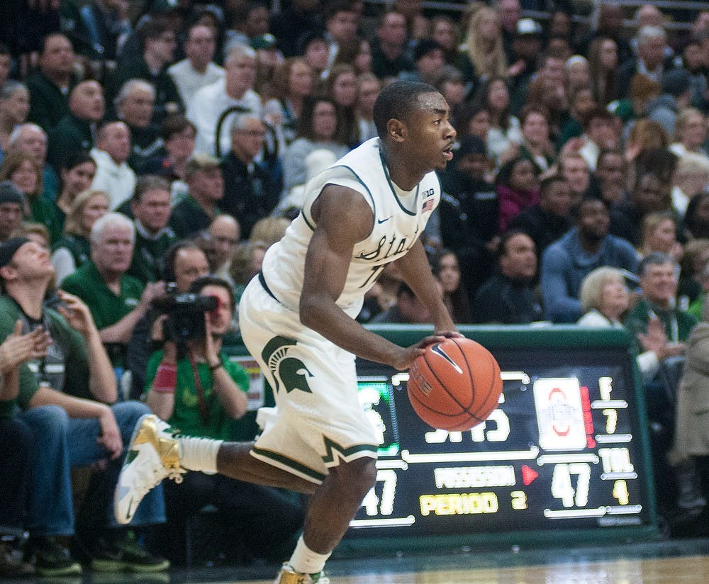 <p>Freshmen guard Lourawls 'Tum Tum' Nairn Jr. dribbles the ball Feb. 14, 2015, during the game against Ohio State at Breslin Center. The Spartans defeated the Buckeyes, 59-56. Hannah Levy/The State News</p>