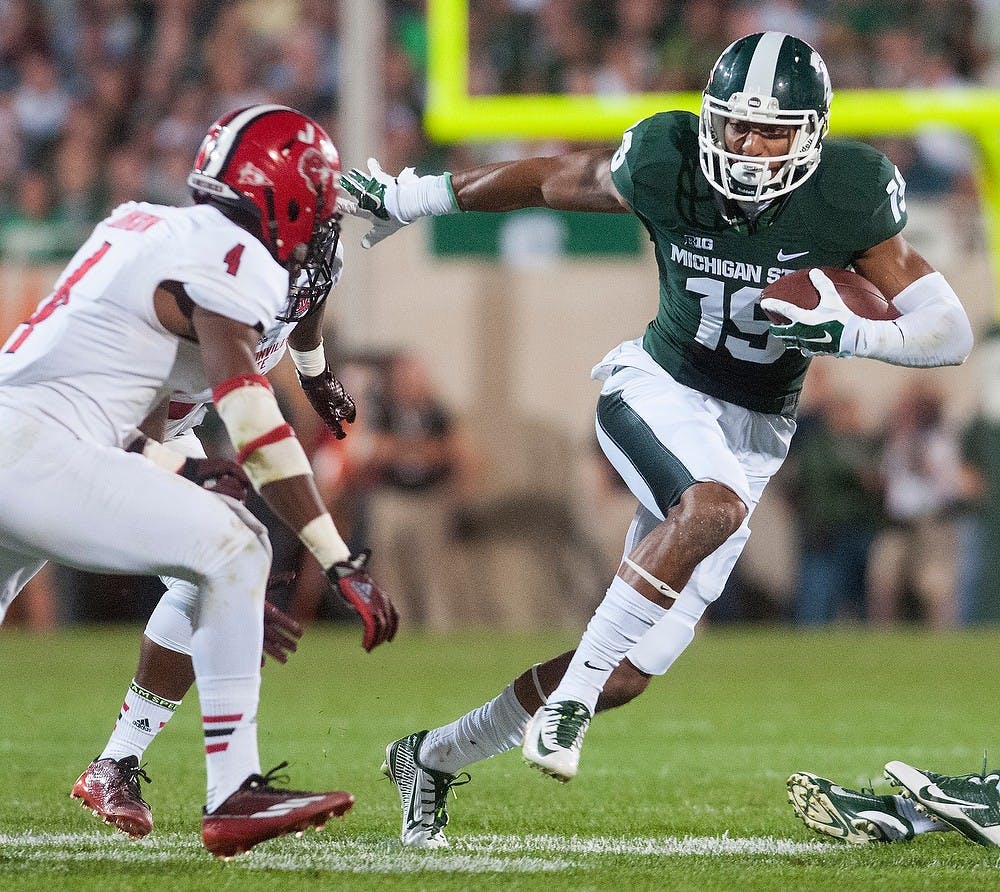 <p>Then-junior wide receiver AJ Troup weaves past Jacksonville State safety Folo Johnson, 4, on Aug. 29, 2014, at Spartan Stadium. The Spartans defeated the Gamecocks, 45-7. Julia Nagy/The State News</p>