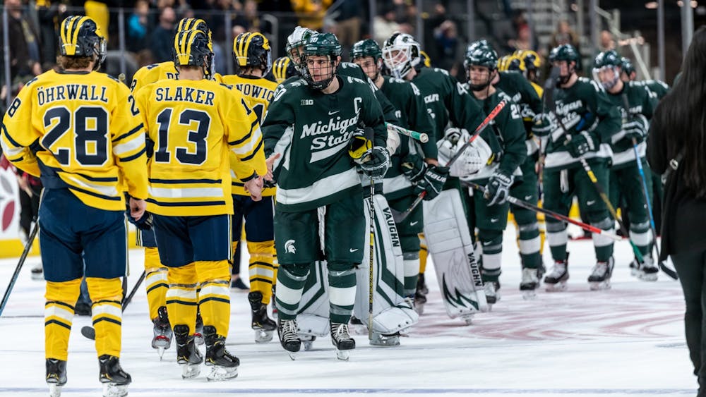 <p>Senior right wing Sam Saliba (10) and the Spartan hockey team shake hands with Michigan players following a game. The Spartans fell to the Wolverines, 1-4, at Little Caesars Arena on February 17, 2020. </p>