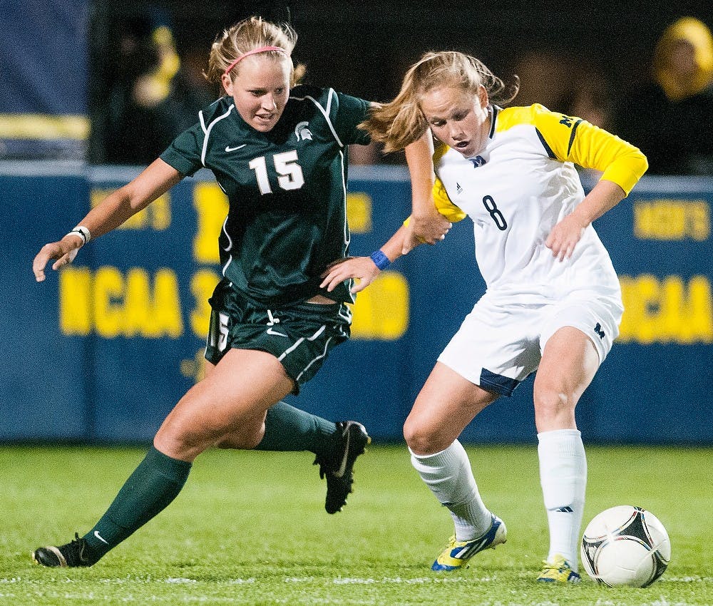 	<p>Junior defender Kelsey Mullen tries to steal the ball away from Wolverine midfielder Tori McCombs on Wednesday, Oct. 10, 2012 at the U-M Soccer Stadium in Ann Arbor. The Spartans gained momentum in the first half after scoring a goal, but could not overcome the Wolverines in the end, losing 2-1 in overtime. Julia Nagy/The State News</p>