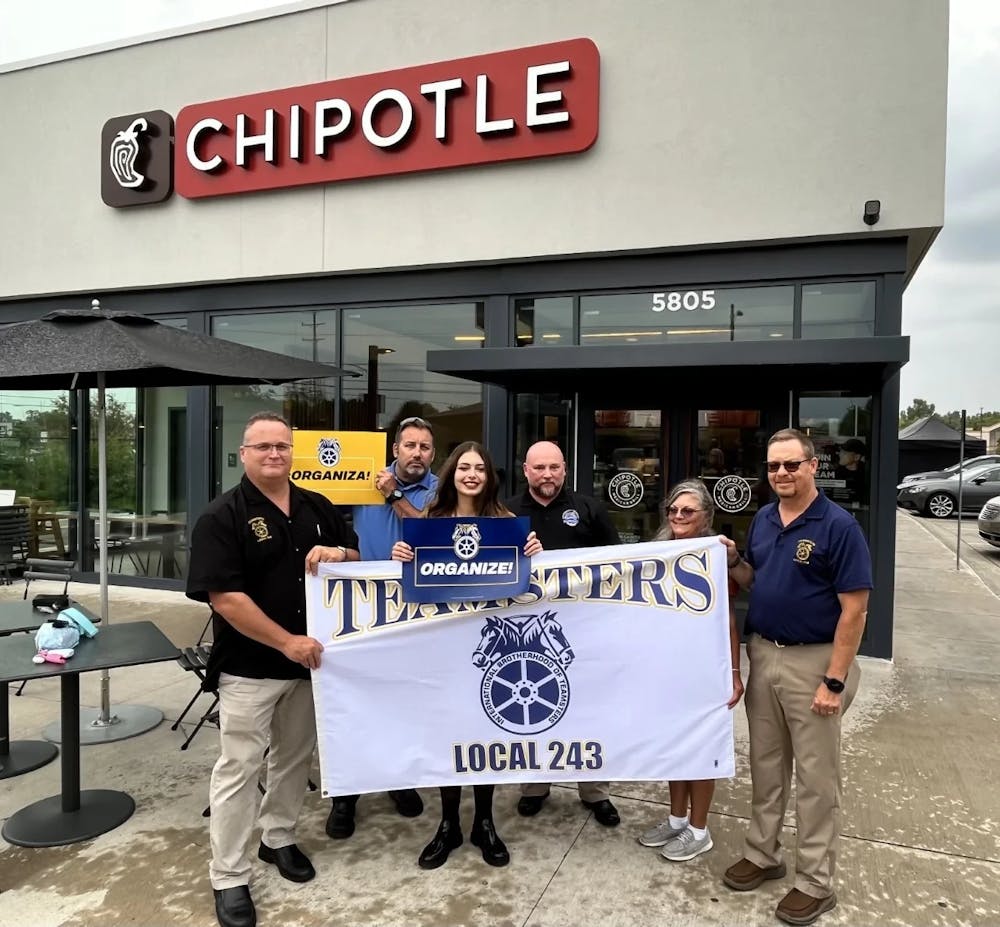 <p>Organizers at the Chipotle on West Saginaw Highway pose in front of the store – <em>Courtesy of the International Brotherhood of Teamsters</em></p>