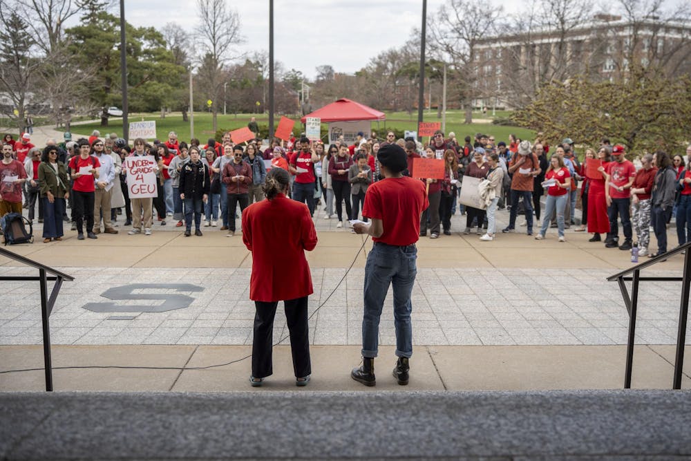 Speakers address over 100 attendees of the Stand Up for Higher Education Rally outside the Hannah Administration Building on April 17, 2025.