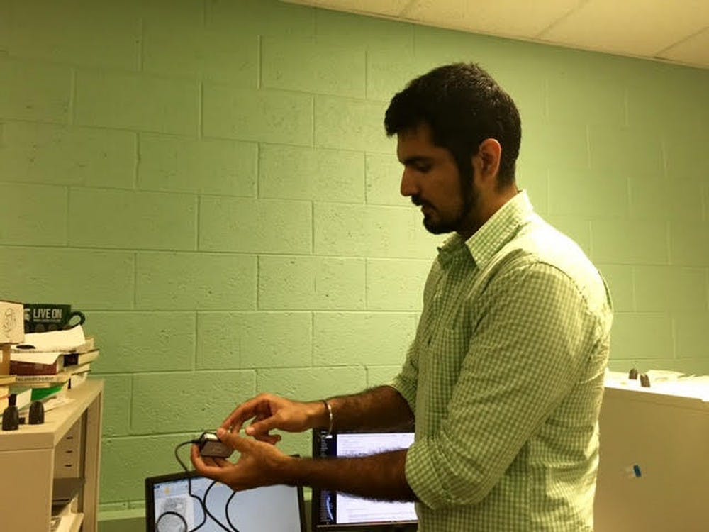 Graduate student Sunpreet Arora demonstrates finger printing on July 26, 2016  at the Pattern Recognition and Image Processing, or PRIP, lab. Photo courtesy of the Department of Computer Science and Engineering.