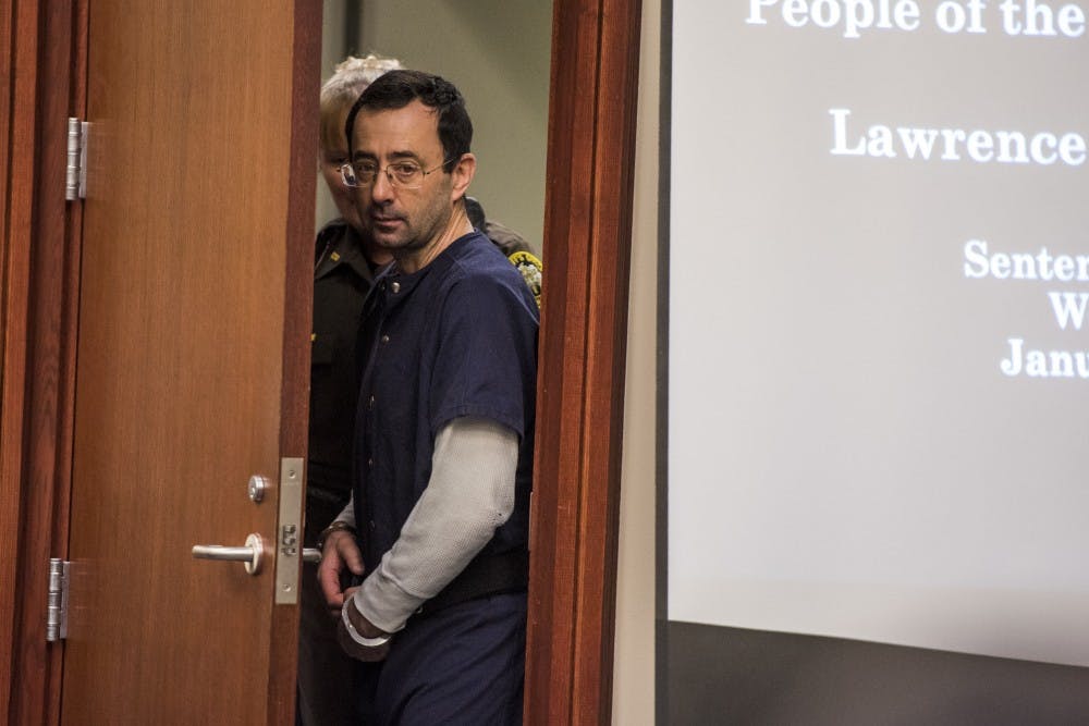 <p>Ex-MSU and USA Gymnastics Dr. Larry Nassar enters the court room on the seventh and final day of his sentencing on Jan. 24, 2018 at the Ingham County Circuit Court in Lansing.</p>