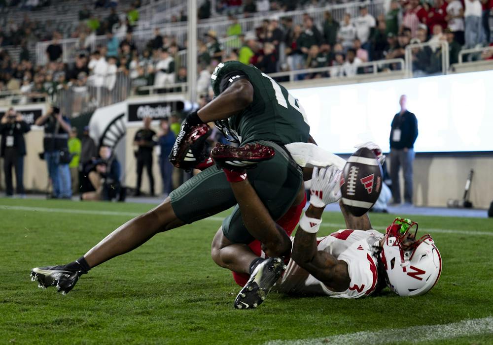 <p>Michigan State redshirt sophomore defensive back Andrew Brinson IV (14) falls on Nebraska junior wide receiver Kwazi Gilmer (3) in the end zone during the Spartans’ game against Nebraska at Spartan Stadium in East Lansing, Mich., on Saturday, Sept. 26, 2026.</p>
