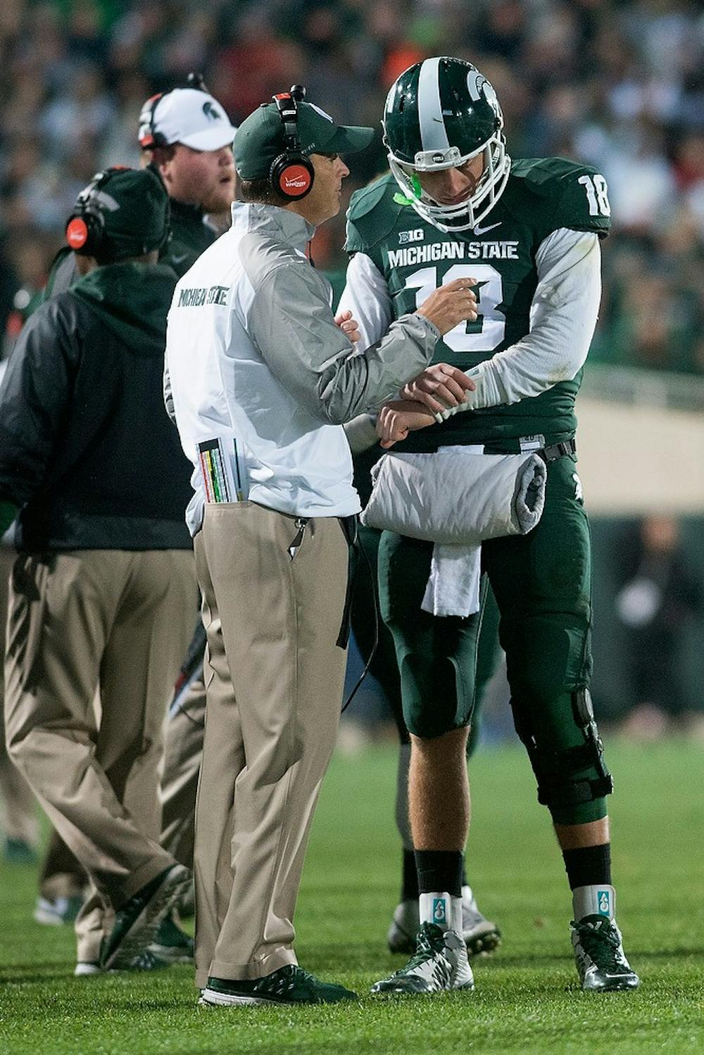 <p>Quarterbacks coach Brad Salem talks to junior quarterback Connor Cook during the game against Nebraska on Oct. 4, 2014, at Spartan Stadium. The Spartans defeated the Huskers, 27-22. Julia Nagy/The State News</p>