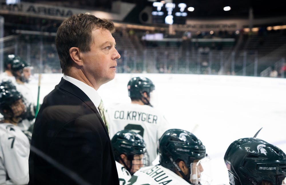 <p>MSU Men’s Hockey Head Coach Adam Nightingale watches players during a game against the University of Massachusetts at Munn Ice Arena on Oct. 13, 2022. The Spartans defeated the Minutemen with a score of 4-3. </p>