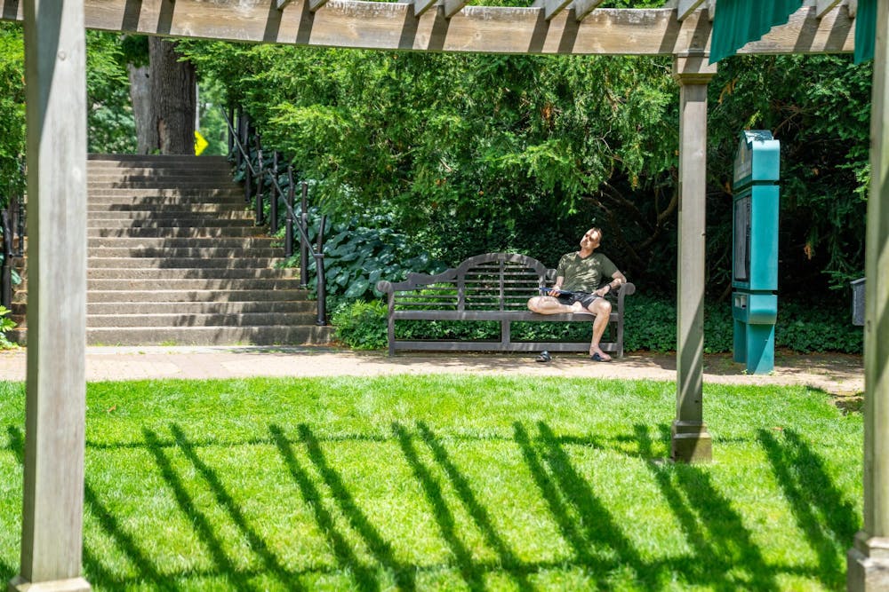 <p>A person sits on a bench in the W.J. Beal Botanical Garden in East Lansing, Mich., on June 28, 2026.</p>
