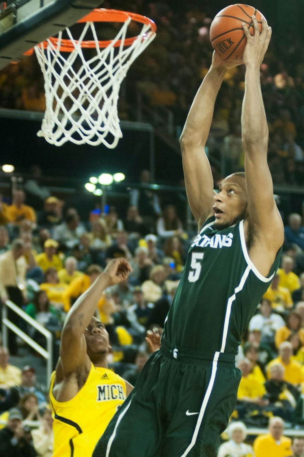 	<p>Senior center Adreian Payne goes up for a dunk over Michigan forward Glenn Robinson <span class="caps">III</span> on Feb. 23,  2014, at Crisler Center in Ann Arbor, Mich. The Spartans were defeated by the Wolverines, 79-70. Danyelle Morrow/The State News</p>