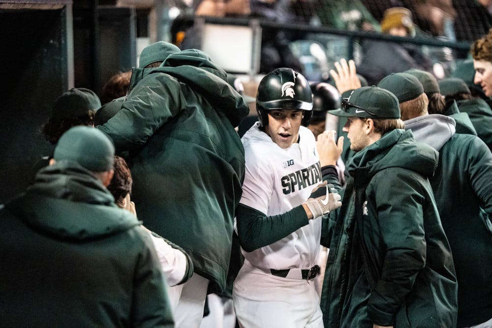 <p>Redshirt freshman catcher Bryan Broecker (19) is celebrated as he returns to the dugout after making it to home plate. MSU faced Notre Dame at Comerica Park on April 26, 2022.</p>