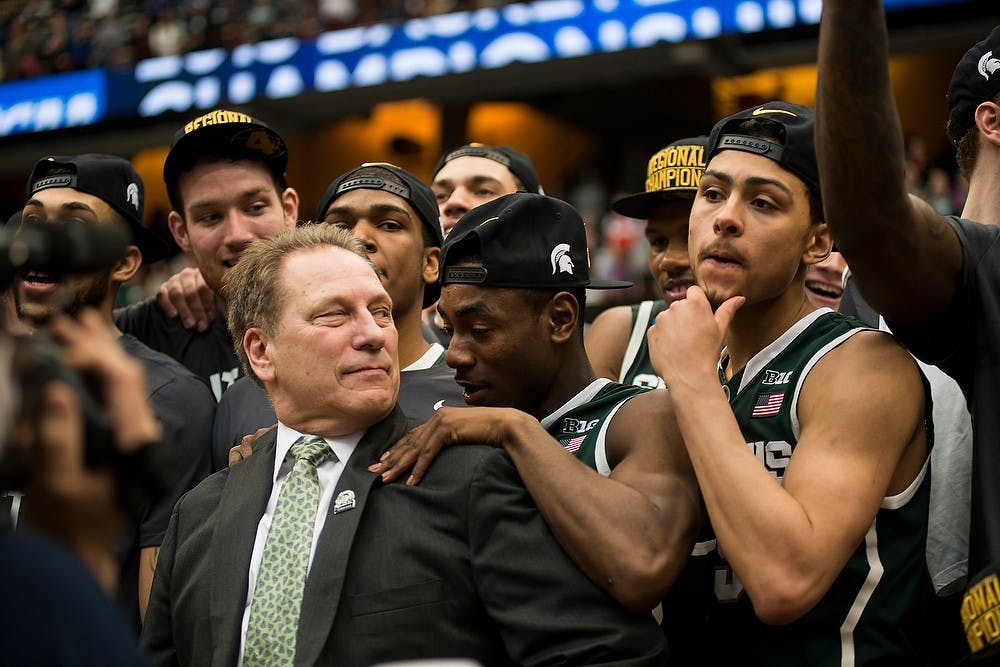 <p>Head coach Tom Izzo looks back at his team before receiving the NCAA Eastern Regional trophy March 28, 2015, during the East Regional round of the NCAA Tournament in the Elite Eight against Louisville at the Carrier Dome in Syracuse, New York. The Spartans defeated the Cardinals in overtime, 76-70.</p>