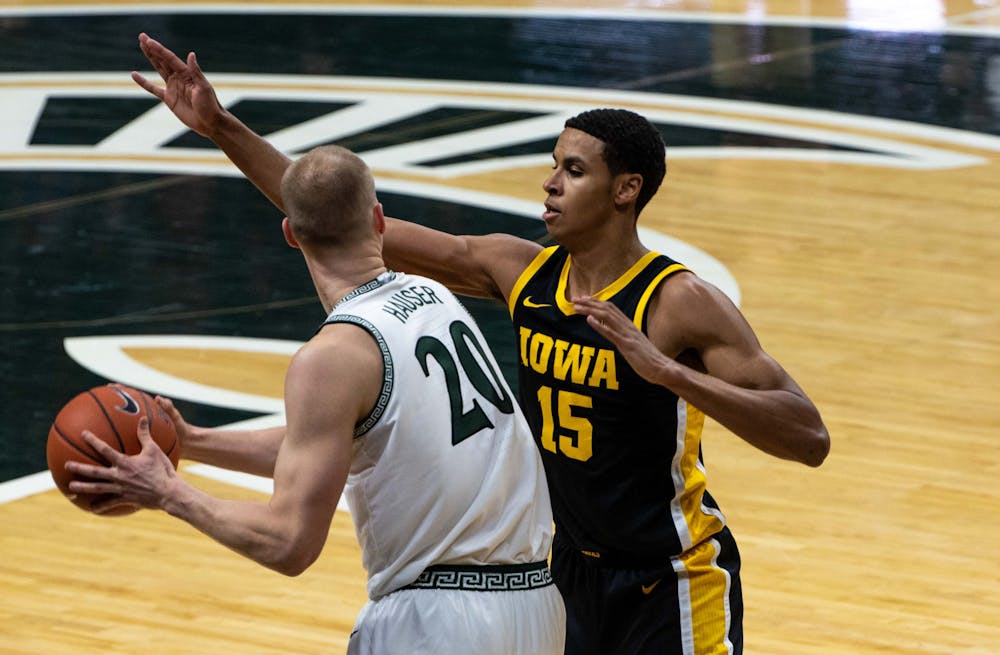 <p>Then-redshirt junior forward Joey Hauser (20) attempts to get around Iowa&#x27;s then-freshman Keegan Murray in the first half. The Spartans were crushed by the Hawkeyes, 88-58, on Feb. 13, 2021.</p>