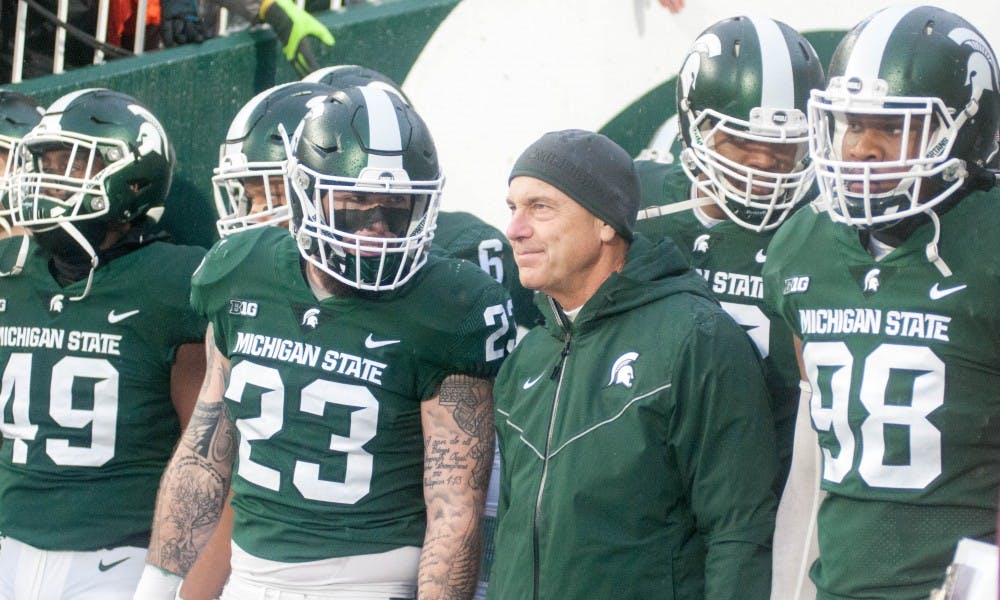 Head Coach Mark Dantonio and the Spartans take the field before the game against Maryland on Nov. 18, 2017, at Spartan Stadium. The Spartans defeated the Terrapins 17-7.
