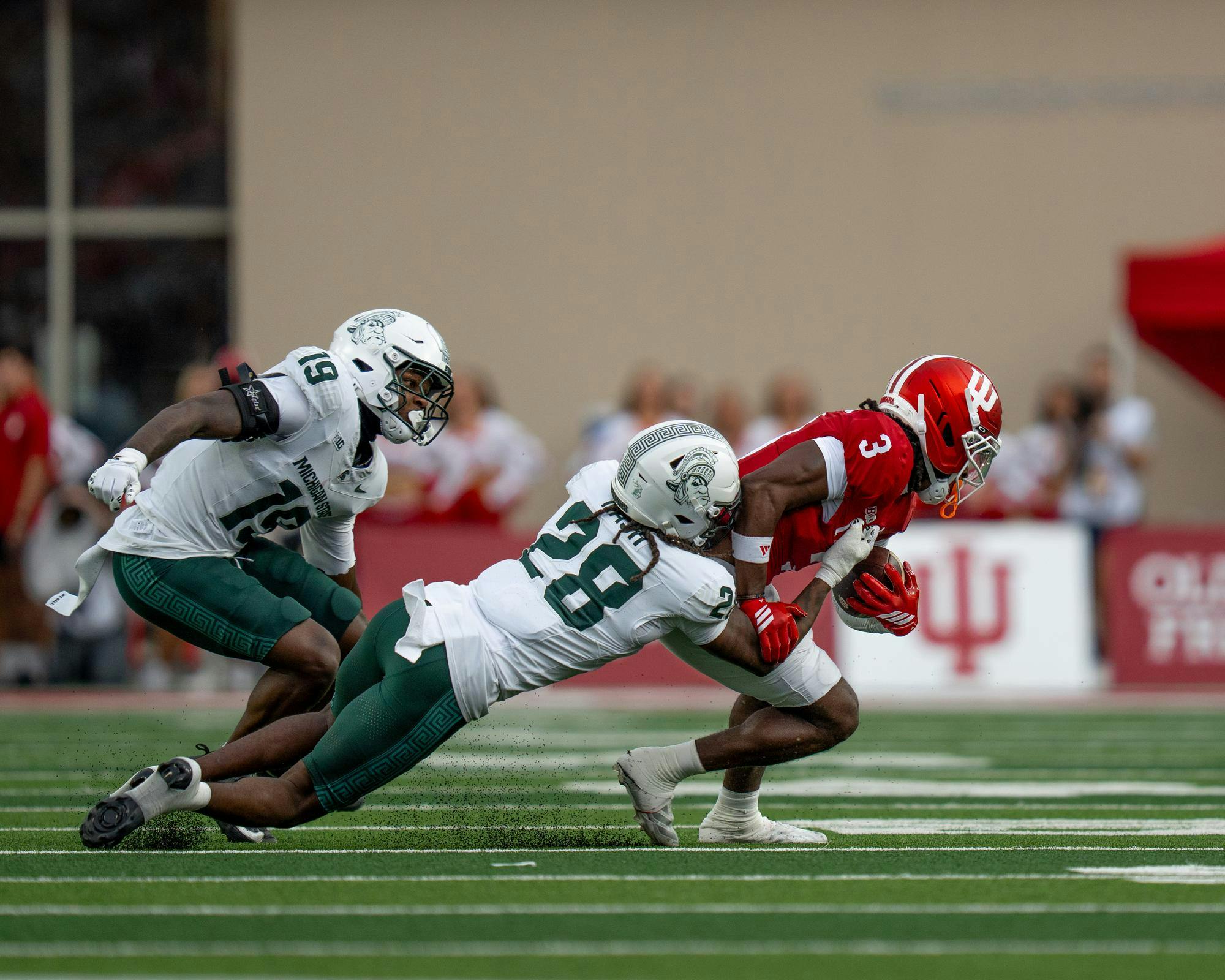 MSU DB Dontavius Nash (28) tackles Indiana WR Omar Cooper Jr. (3) in Bloomington, IN on Oct. 18, 2025.