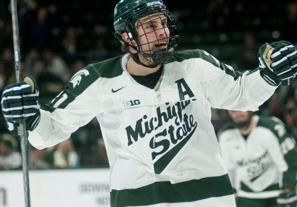 <p>Junior forward Joe Cox celebrates after a goal during the third period of the game against New Hampshire on Nov. 7, 2015, at Munn Ice Arena. The Spartans defeated the Wildcats, 7-4.</p>