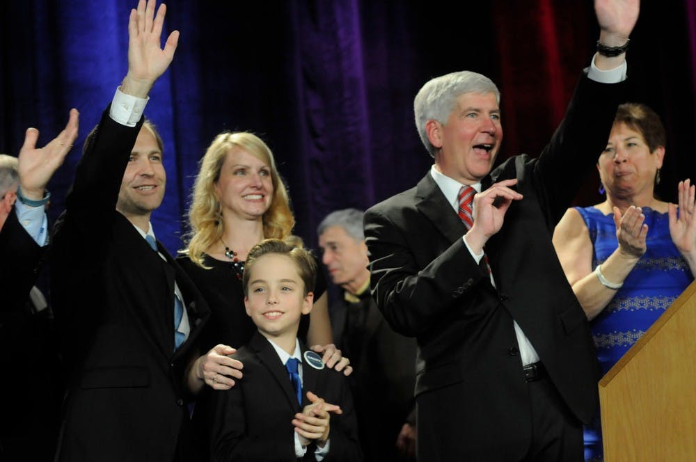 <p>Lt. Governor Brian Calley, wife Julie Calley, and son Collin Calley celebrate with Govenor Rick Snyder on Nov. 4, 2014, at the Detroit Marriott at the Renaissance Center in Detroit, Mich. Snyder had just won a second term in office as governor. Jessalyn Tamez/The State News</p>